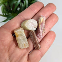 Thumbnail for A person holds two crystals from the Tourmaline Pink & Green Miner’s Rough 4 Piece Parcel #R191