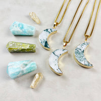 Three gold Tree Agate crescent moon necklaces with marbled inlay