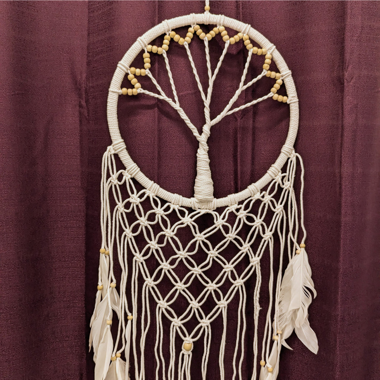 Macramé crochet dreamcatcher featuring Tree of Life design and hanging feathers