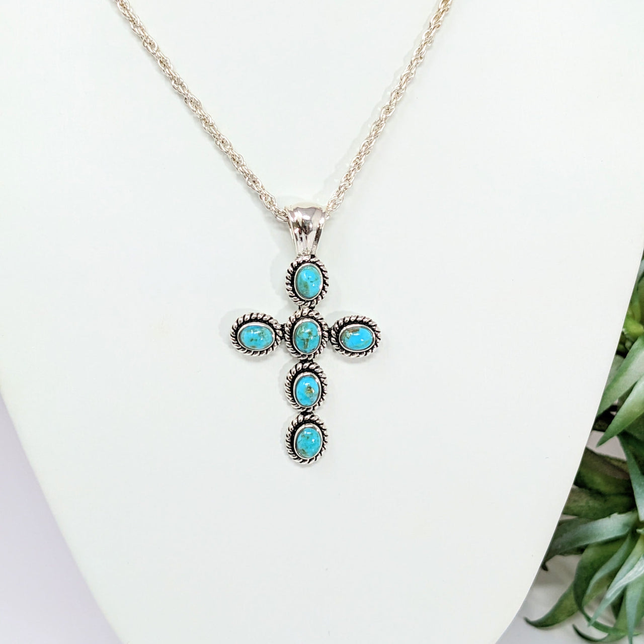 Turquoise 1.5’ Cross Pendant #LV2798 on white mannequin with turquoise stones