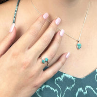 Thumbnail for Woman wearing sterling silver turquoise ring and necklace from a crystal jewelry gift set