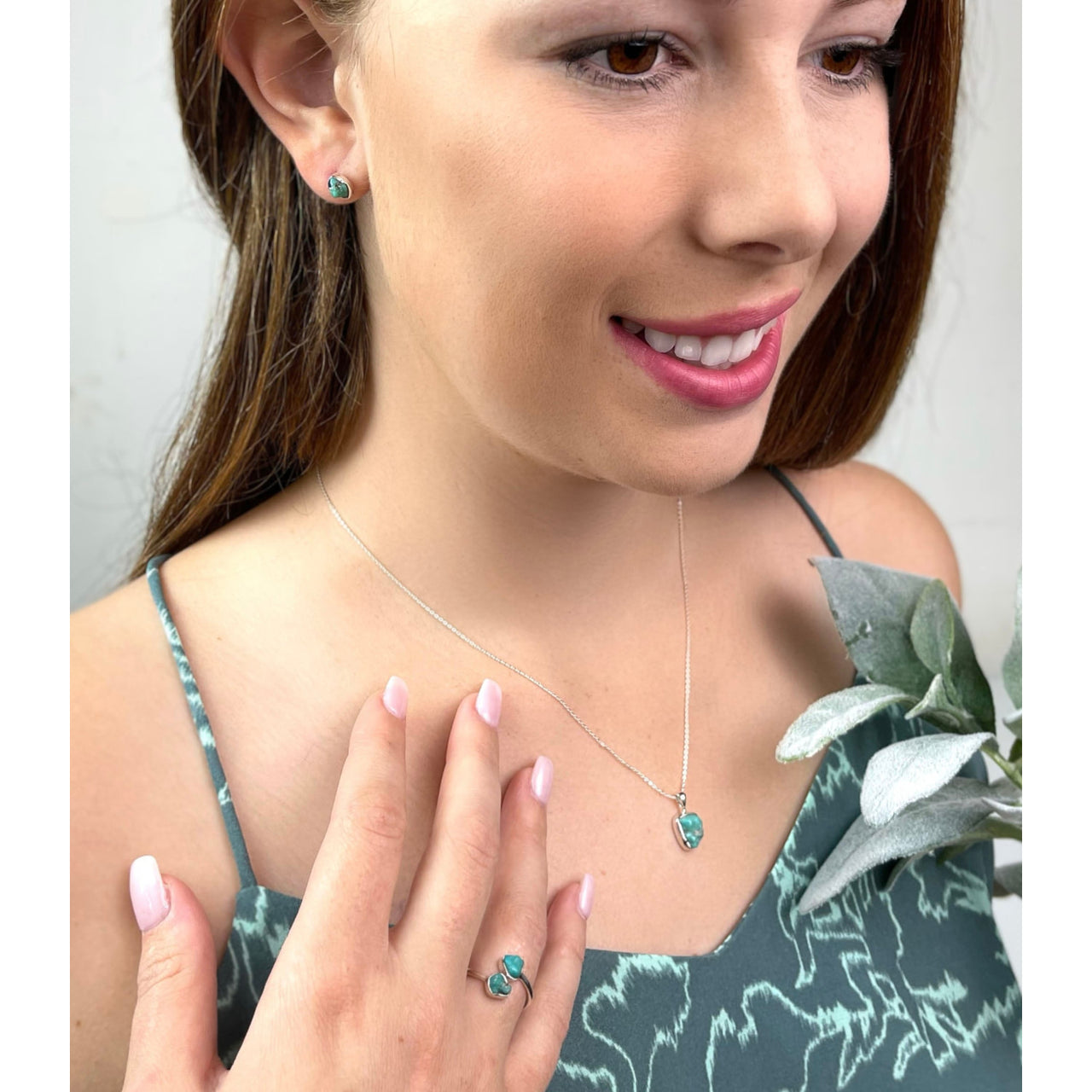 A woman wearing a green and white necklace from the Sterling Silver Turquoise Jewelry Gift Set