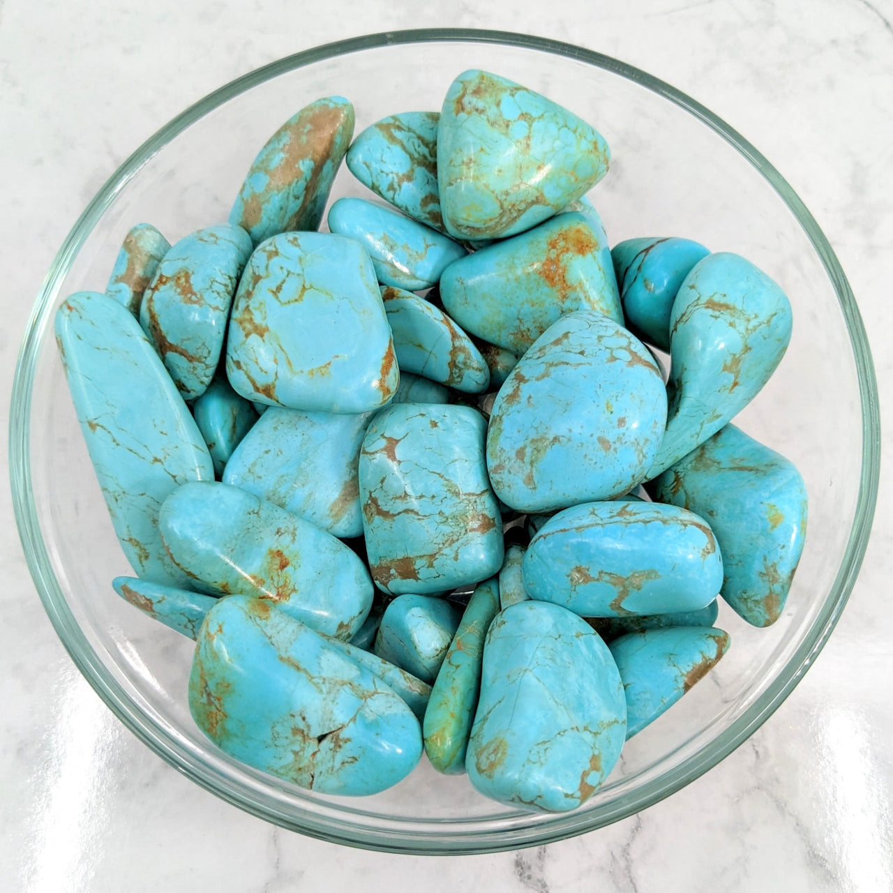 Close up of turquoise tumbled stones in a bowl, featuring Turquoise Mexican #LV3057