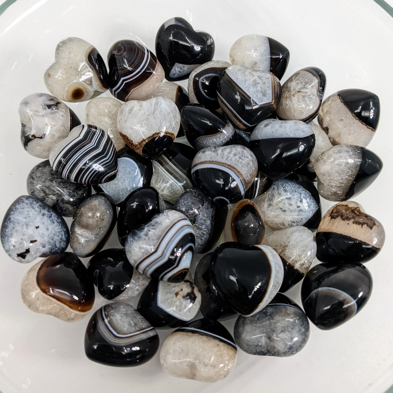 A bowl filled with black and white marble featuring Tuxedo Agate Heart (7g) #SK9000