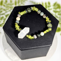 Uplifting 7 inch multi stone jewelry bracelet with lime green crystals white and gray gemstones and a hexagonal centerpiece crystal