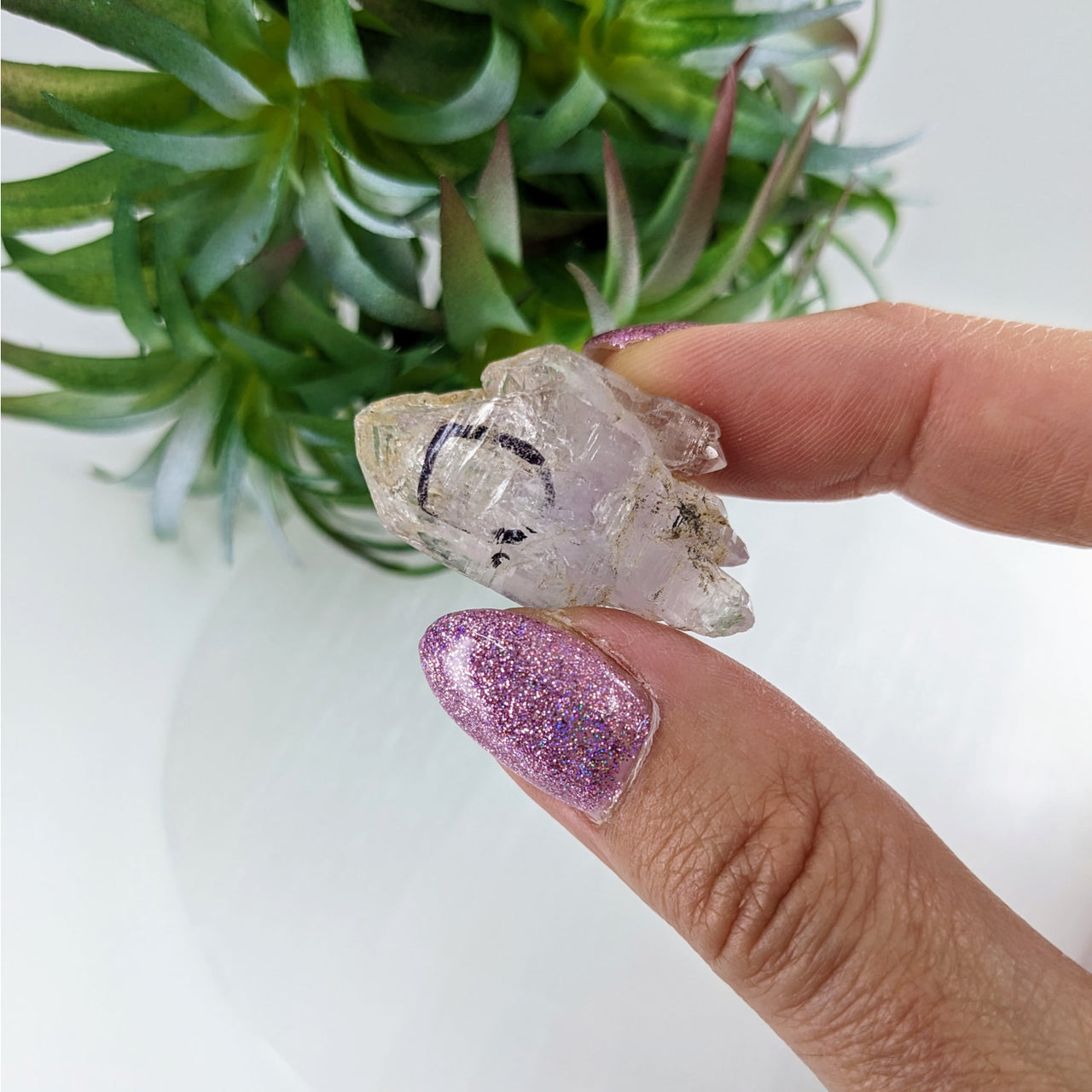 Person holding Veracruz Amethyst 1.4’ Enhydro Point #LV3384 crystal quartz piece