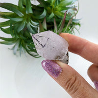 Thumbnail for Person holding small Veracruz Amethyst 1.75’ Enhydro Point quartz crystal #LV3379