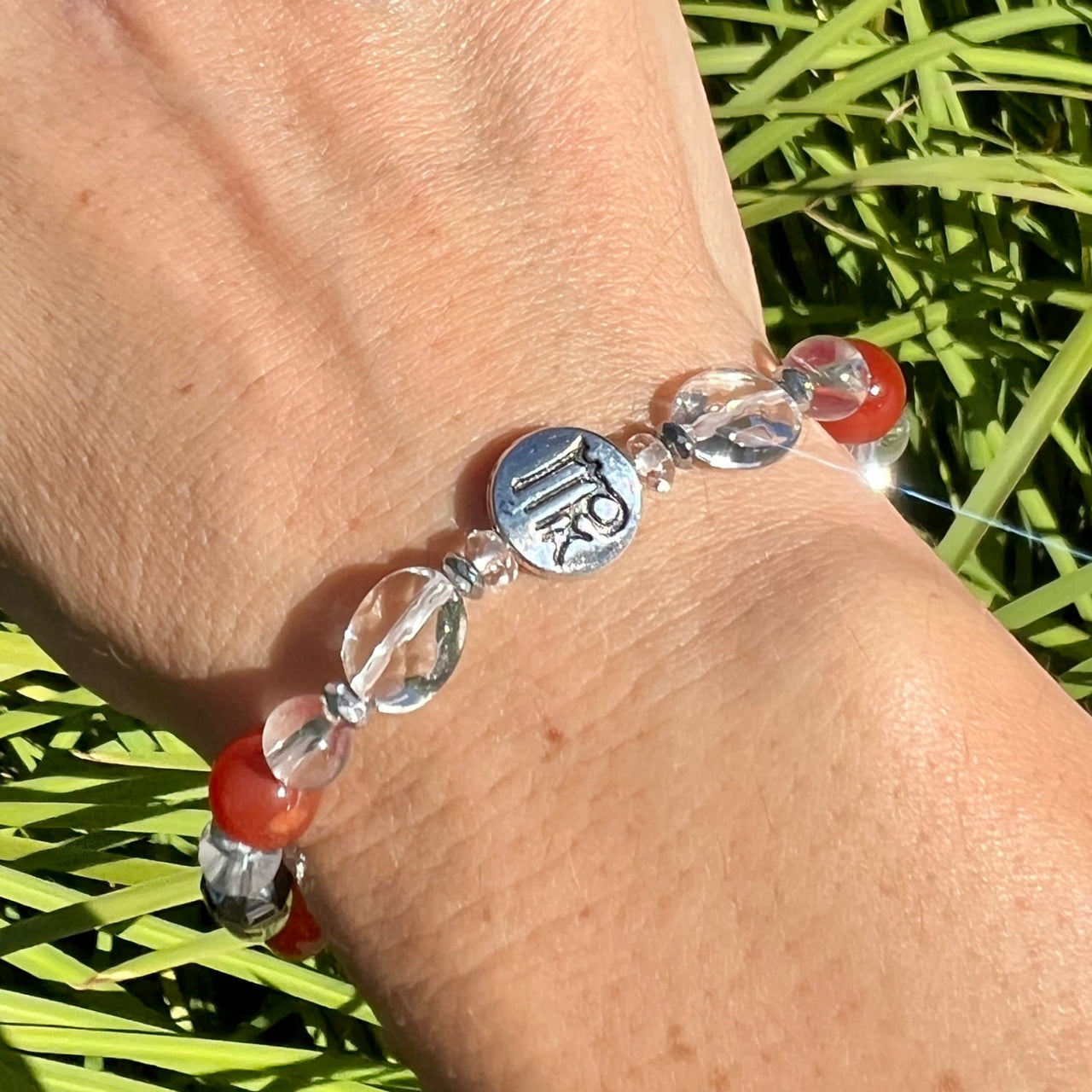 Person wearing Virgo Zodiac Handmade Beaded Bracelet with red bead, 7’ Astrology Sign Jewelry