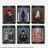 Set of six black-bordered tarot cards from wednesday official oracle deck featuring characters with gemstone details