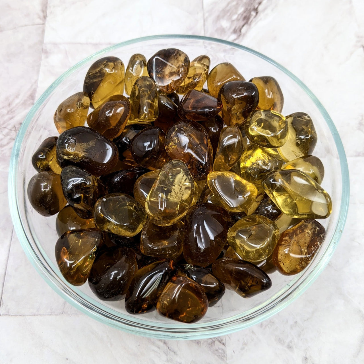 A bowl of tumbled stones boasting smoky quartz for positive energy - Whiskey Quartz #LV2275