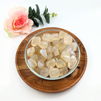 Thumbnail for A bowl of sea glass with White Agate Tumbled Stones on a wooden plate, product #LV3071