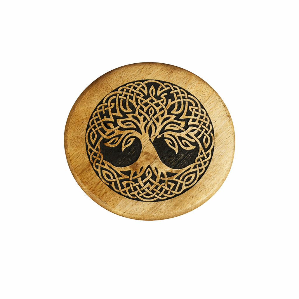 Wooden altar stool featuring circular coaster with dark carved celtic knot and tree of life design on natural wood grain