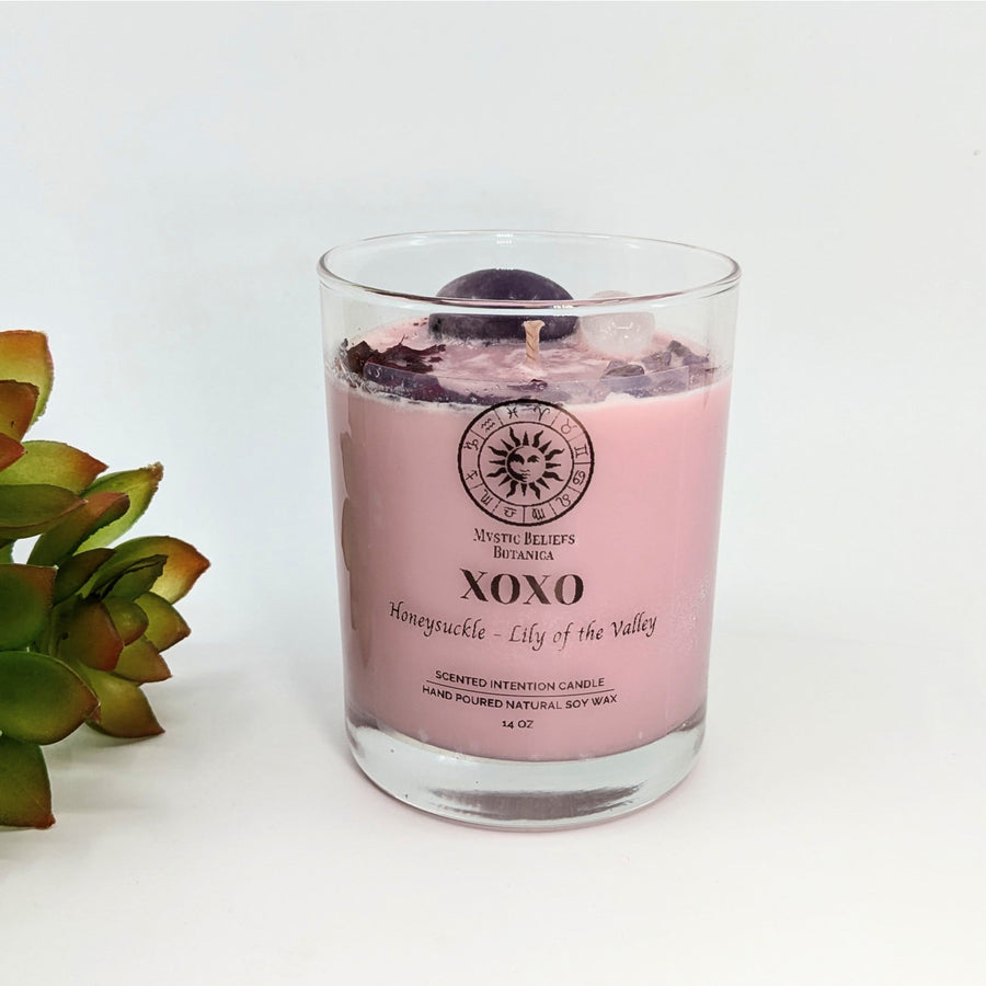 Pink candle in a glass jar from XOXO LILY Scented Intention Soy Candle with Crystals and Flowers