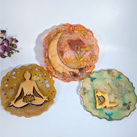 Three scalloped resin coasters with yoga pose, moon, butterfly designs