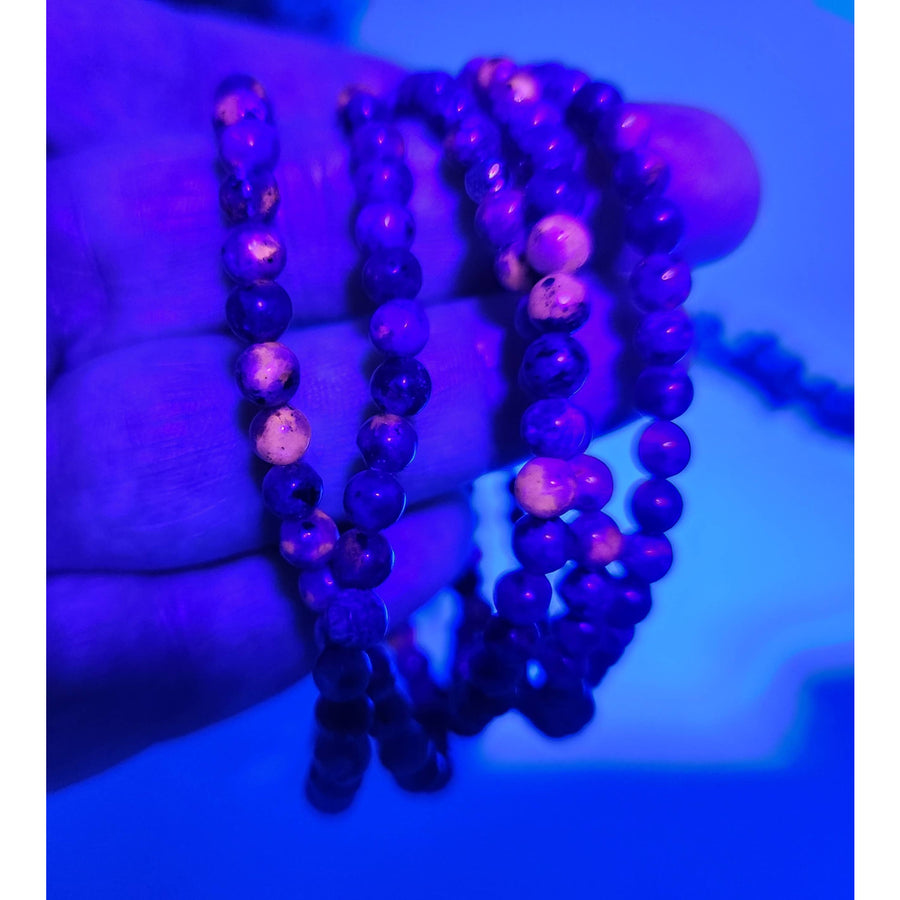 Multi-colored Yooperlite stretchable gemstone bracelet with purple, blue, pink beads