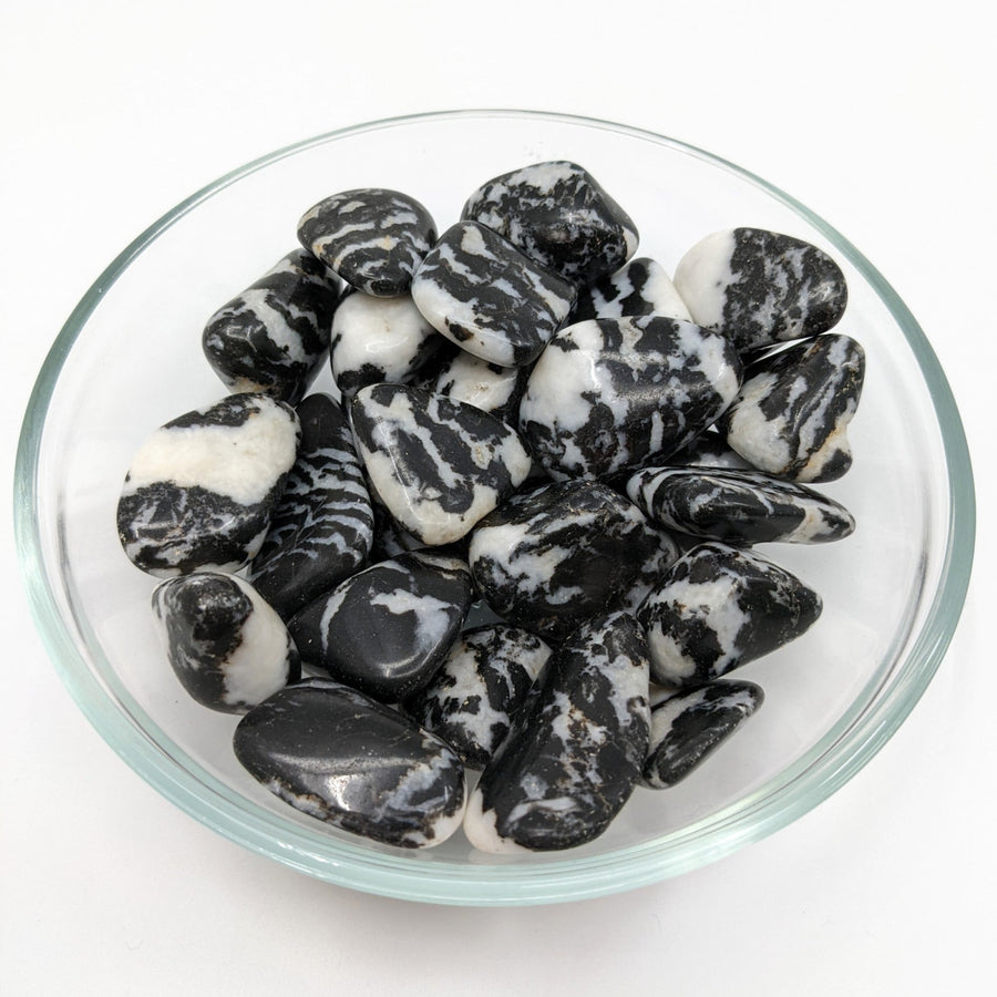 A bowl of black and white tumbled stones from the Zebra Jasper Tumbled Stone collection