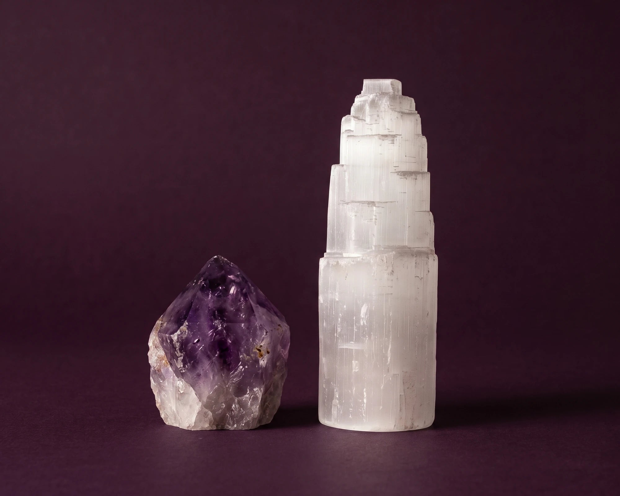 Soothing blue chalcedony stone positioned against throat chakra color background.