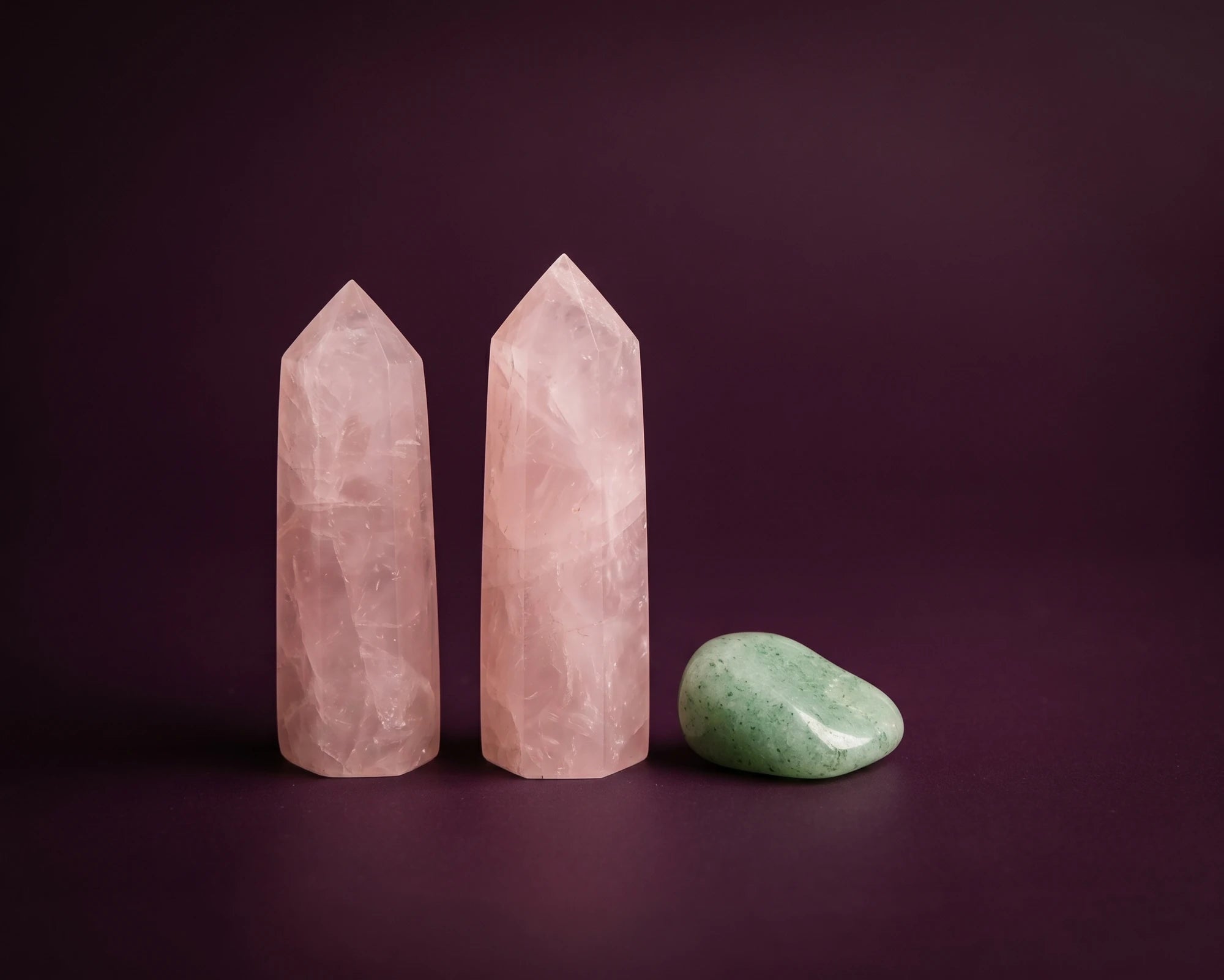 Pink rose quartz cluster resonating with the heart chakra aura.