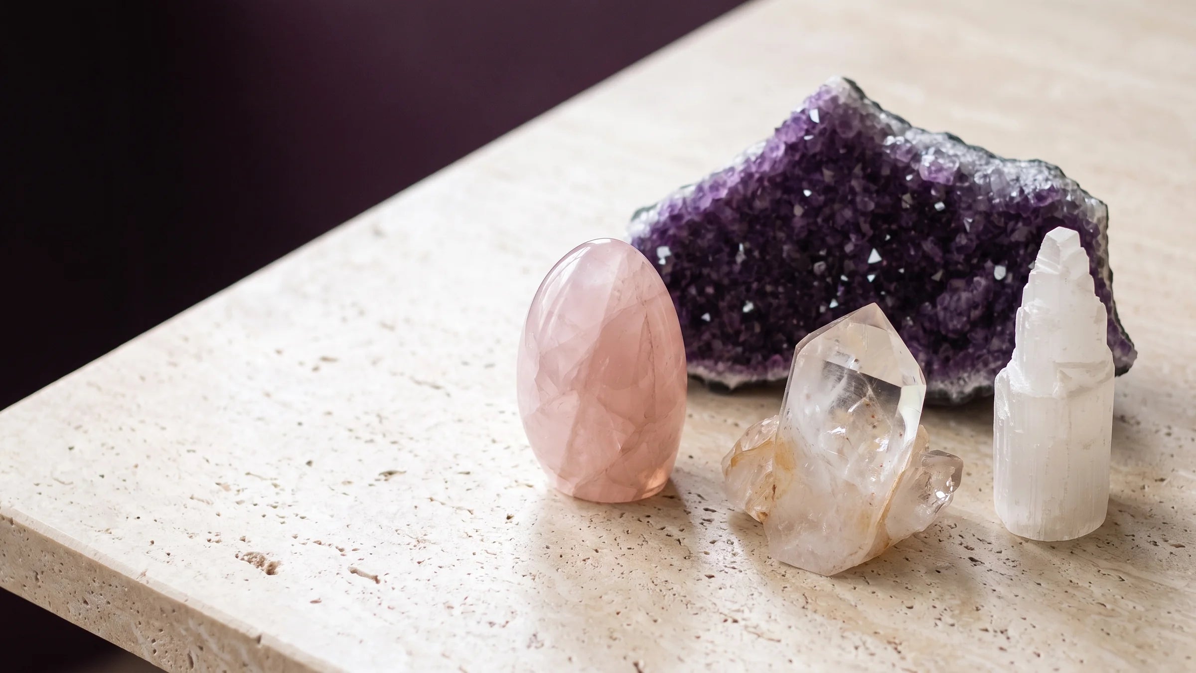 Amethyst, rose quartz, clear quartz and selenite gathered in soft light.
