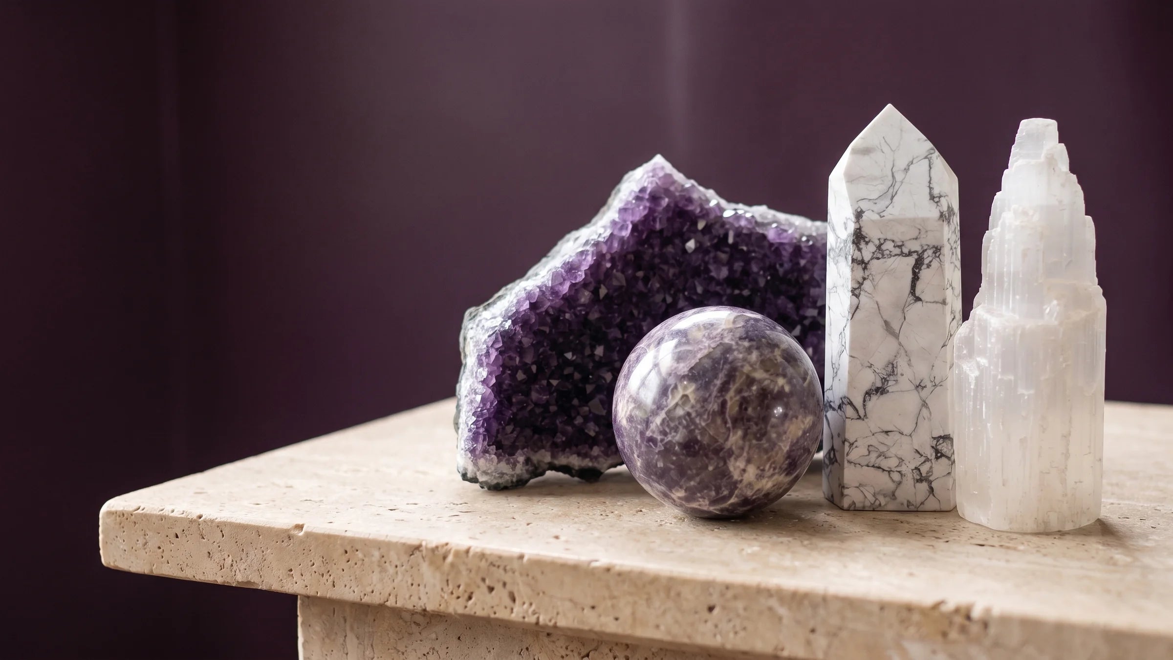 Amethyst, lepidolite, howlite and selenite arranged in calm, low light.