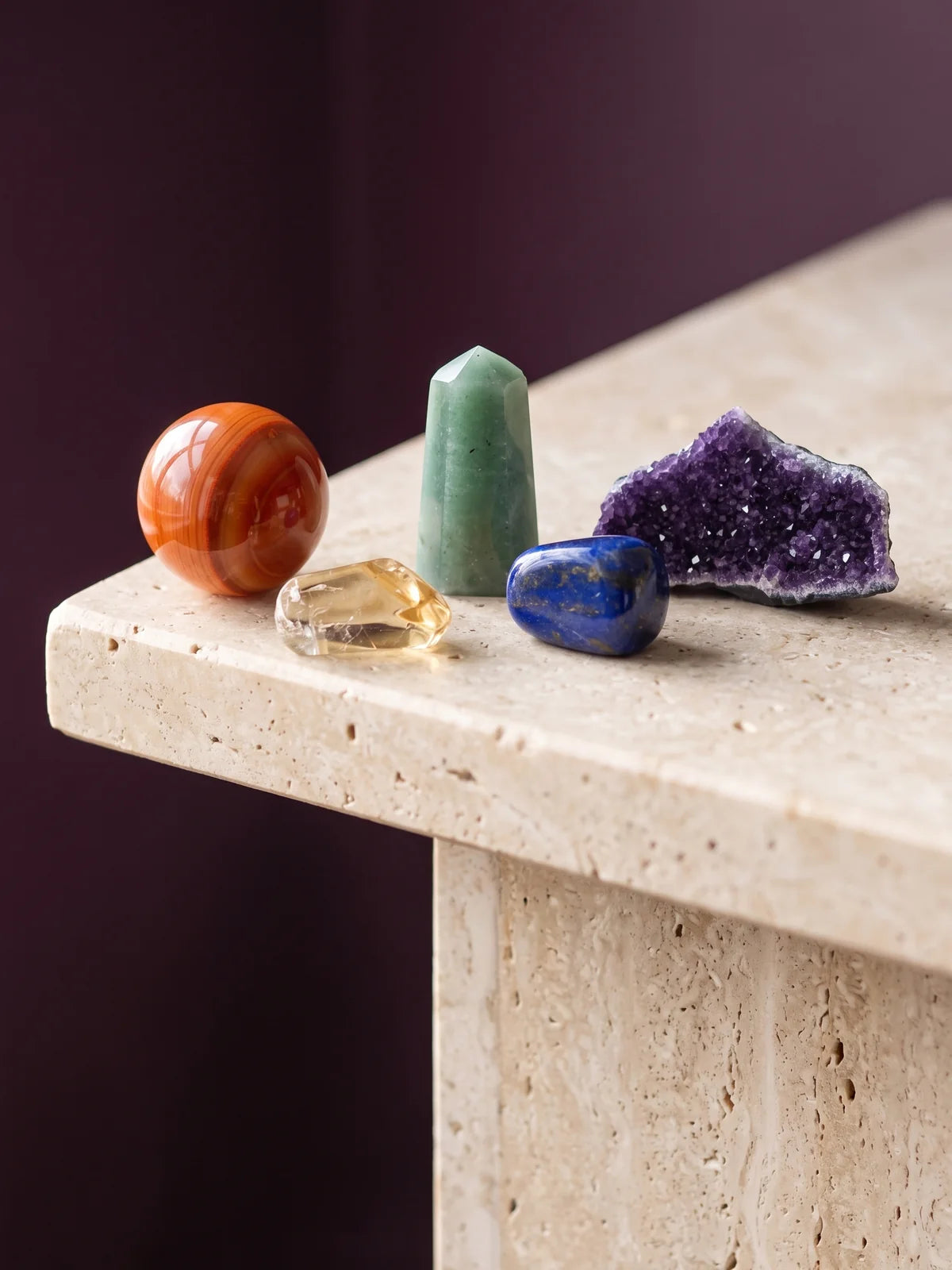 An arc of crystals across the spectrum — carnelian, citrine, green aventurine, lapis lazuli and amethyst.