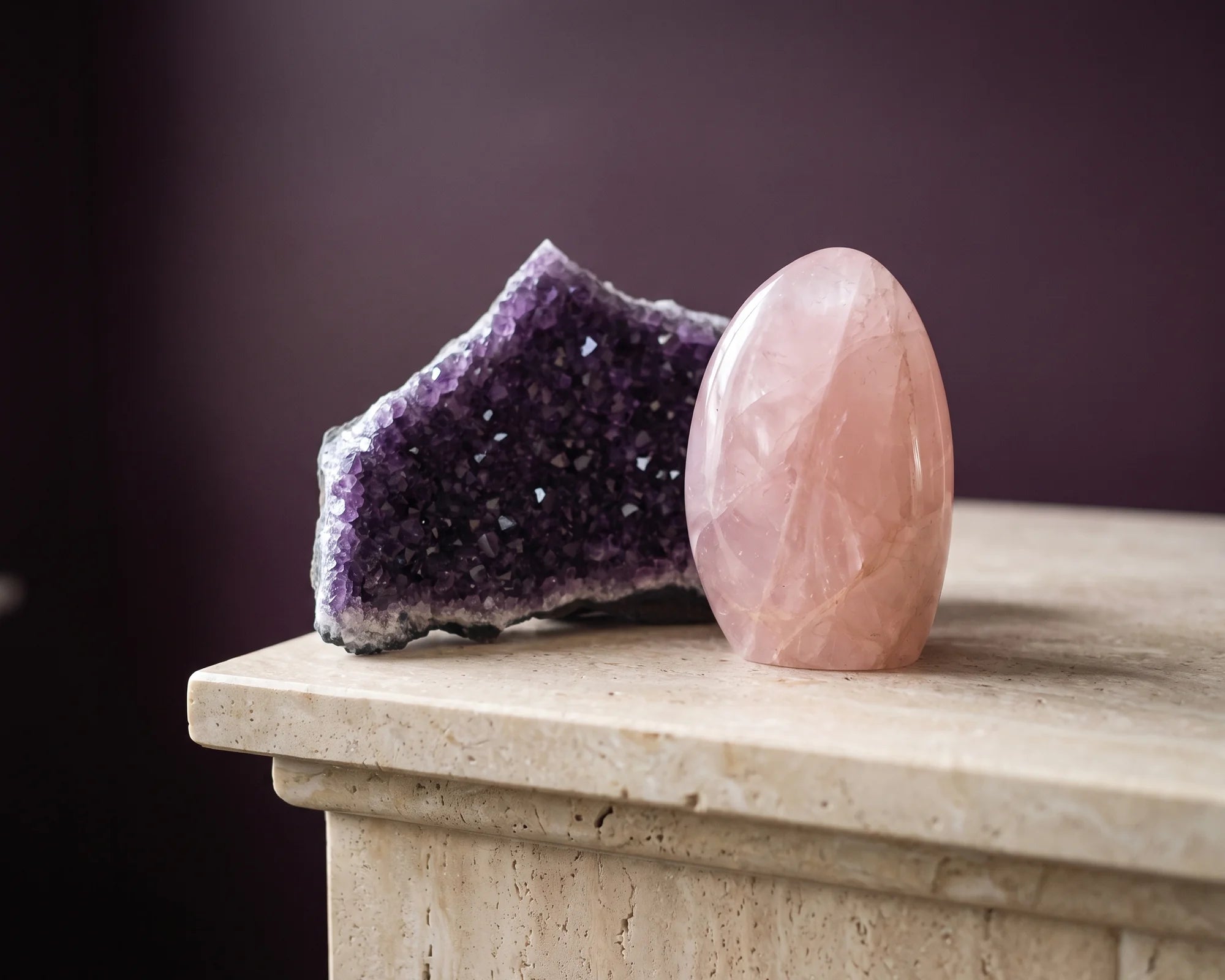 Rose quartz and amethyst resting together in soft light.